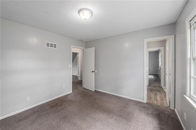 12731 Byars Rd, Grandview, MO 64030 - empty room with carpet flooring and a textured ceiling