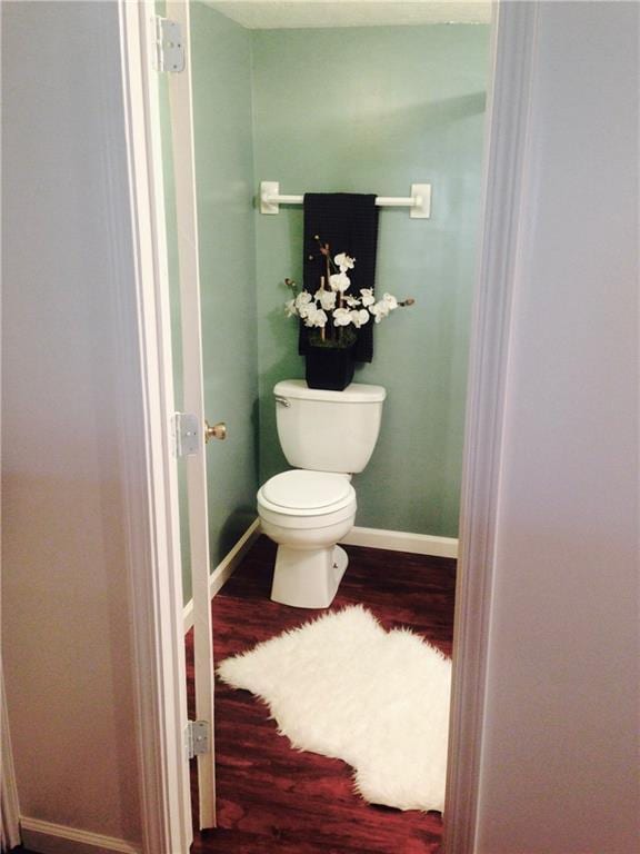12731 Byars Rd, Grandview, MO 64030 - bathroom featuring wood finished floors and toilet
