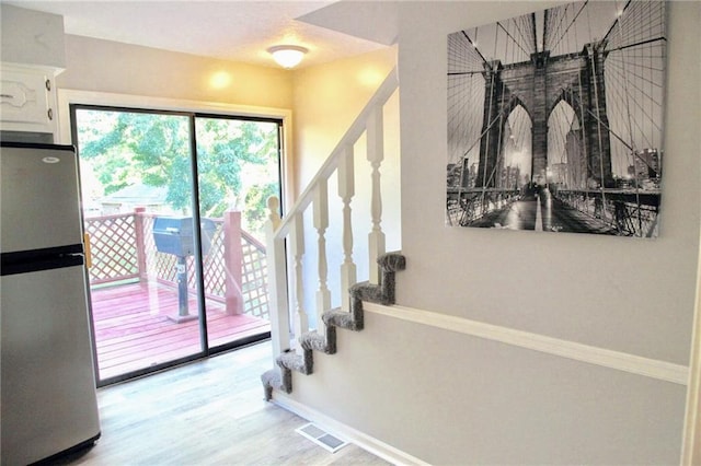 12731 Byars Rd, Grandview, MO 64030 - staircase featuring wood finished floors and baseboards