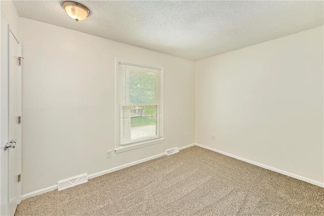 805 NW 18th St, Blue Springs, MO 64015 - spare room with light colored carpet and a textured ceiling