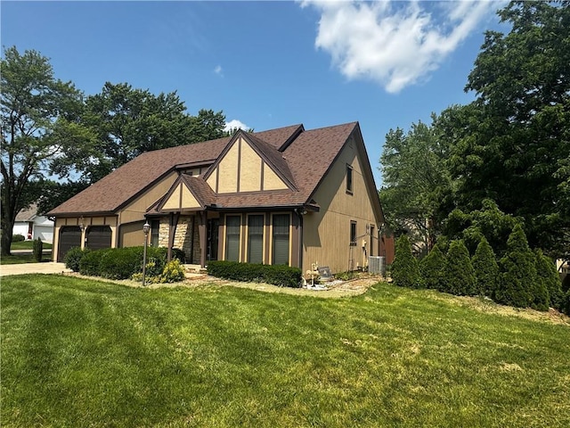 4008 NE 57th Ter, Kansas City, MO 64119 - tudor house featuring a front yard, a garage, and concrete driveway