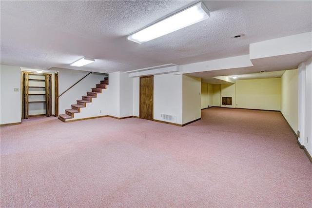 4008 NE 57th Ter, Kansas City, MO 64119 - finished basement with a textured ceiling, carpet, and stairway