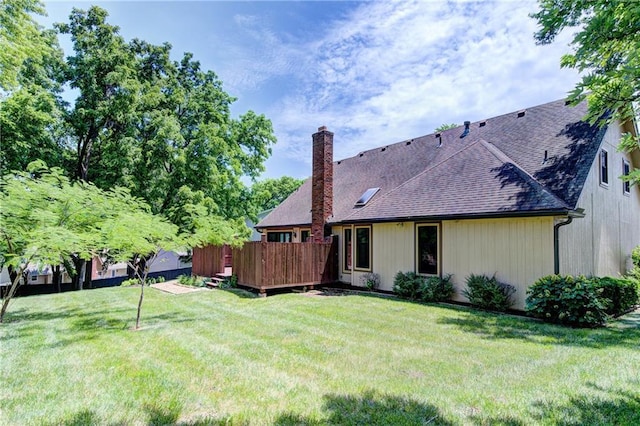 4008 NE 57th Ter, Kansas City, MO 64119 - rear view of property with a chimney, roof with shingles, a lawn, and a deck