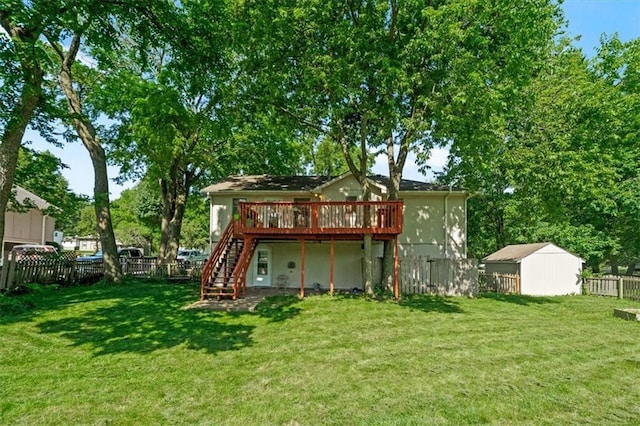 15509 Lawrence Ave, Belton, MO 64012 - rear view of property featuring a deck, stairway, a fenced backyard, and an outbuilding