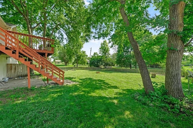 15509 Lawrence Ave, Belton, MO 64012 - fenced backyard featuring stairway and a deck