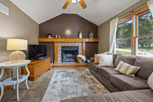 15509 Lawrence Ave, Belton, MO 64012 - living room featuring carpet floors, lofted ceiling, a tiled fireplace, and a ceiling fan