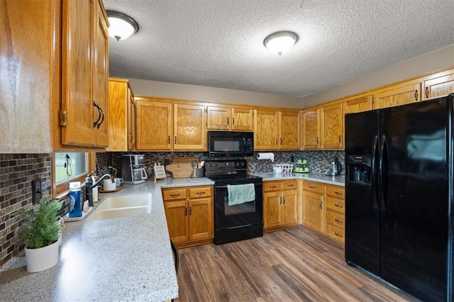 15509 Lawrence Ave, Belton, MO 64012 - kitchen featuring black appliances, light countertops, a textured ceiling, backsplash, and brown cabinets