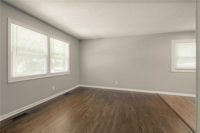 8167 NE 50th St, Kansas City, MO 64119 - empty room featuring dark wood-style floors and a textured ceiling