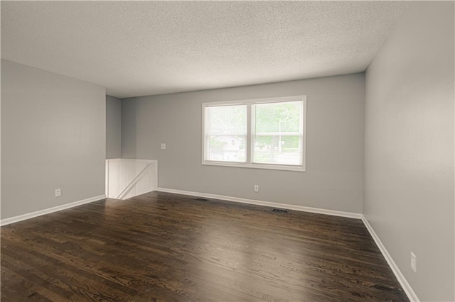 8167 NE 50th St, Kansas City, MO 64119 - spare room with a textured ceiling and dark wood finished floors