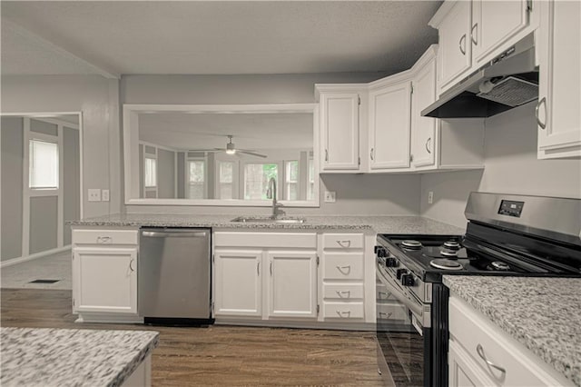 8167 NE 50th St, Kansas City, MO 64119 - kitchen with stainless steel appliances, under cabinet range hood, white cabinets, a ceiling fan, and dark wood finished floors