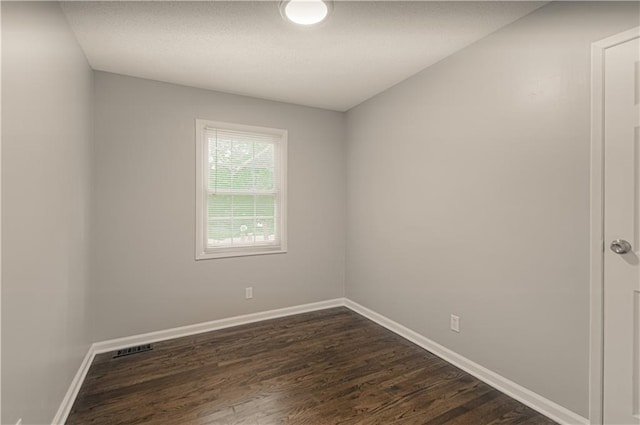 8167 NE 50th St, Kansas City, MO 64119 - empty room featuring dark wood-style flooring and baseboards