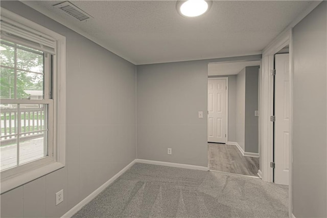 8167 NE 50th St, Kansas City, MO 64119 - spare room featuring carpet and a textured ceiling