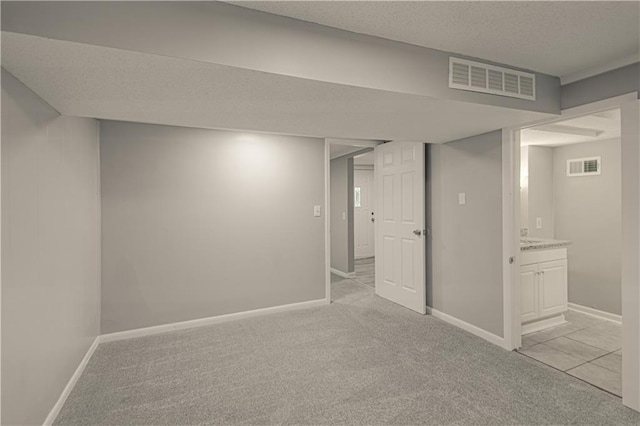 8167 NE 50th St, Kansas City, MO 64119 - finished basement with light colored carpet and a textured ceiling