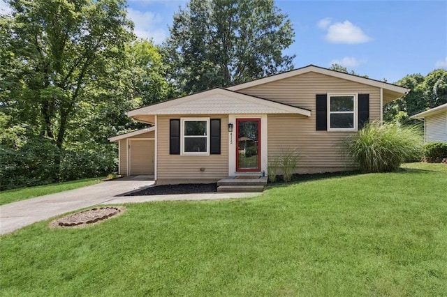 4112 N Hardesty Ave, Kansas City, MO 64117 - view of front of house with a front yard, concrete driveway, and a garage