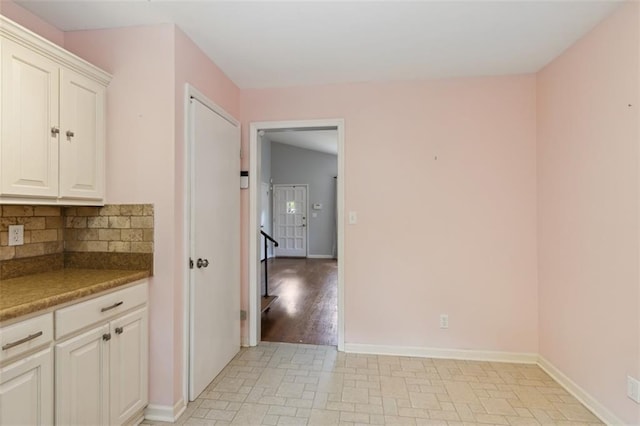 4112 N Hardesty Ave, Kansas City, MO 64117 - kitchen with tasteful backsplash and white cabinets