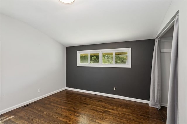 4112 N Hardesty Ave, Kansas City, MO 64117 - unfurnished bedroom featuring dark wood-type flooring and lofted ceiling