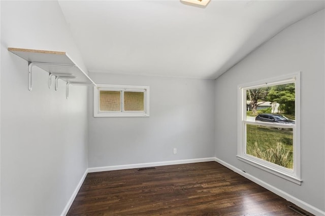 4112 N Hardesty Ave, Kansas City, MO 64117 - empty room featuring lofted ceiling and dark wood-type flooring