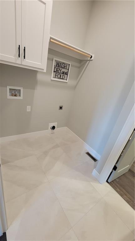 16570 W 170th St, Olathe, KS 66062 - washroom featuring hookup for an electric dryer, hookup for a washing machine, cabinet space, and tile patterned flooring