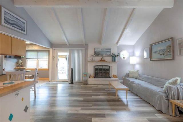 5101 NW Downing St, Blue Springs, MO 64015 - living room featuring light wood-style flooring, beamed ceiling, a fireplace with raised hearth, and high vaulted ceiling