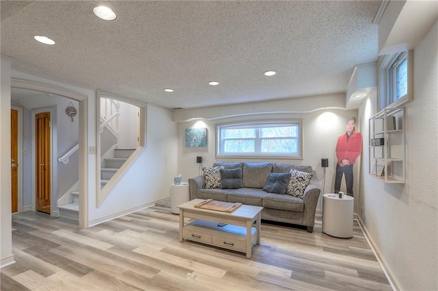 5101 NW Downing St, Blue Springs, MO 64015 - living room with a textured ceiling, light wood-style flooring, recessed lighting, and stairway