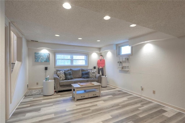 5101 NW Downing St, Blue Springs, MO 64015 - living area featuring recessed lighting, a textured ceiling, light wood-style flooring, and plenty of natural light