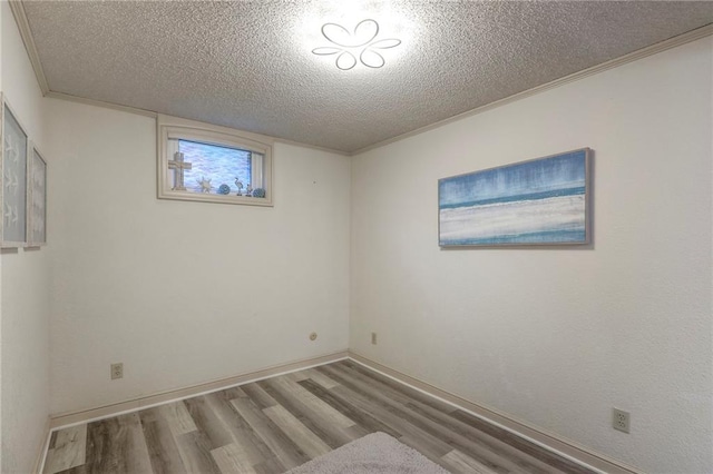 5101 NW Downing St, Blue Springs, MO 64015 - unfurnished room with wood finished floors, a textured ceiling, and ornamental molding