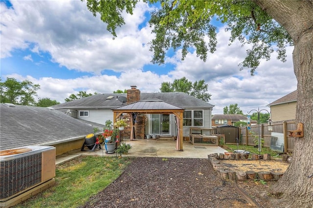5101 NW Downing St, Blue Springs, MO 64015 - back of property featuring a gazebo, a patio, and a chimney