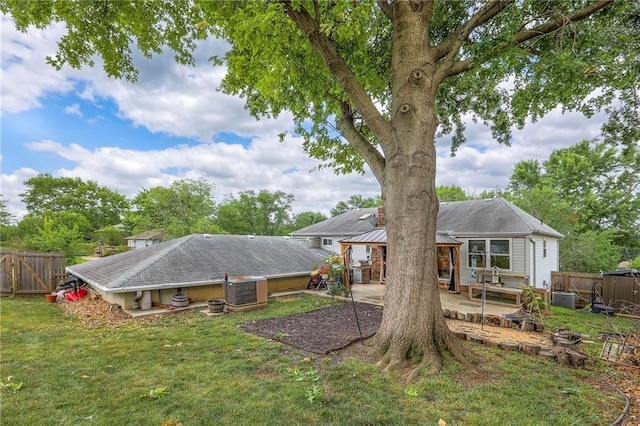 5101 NW Downing St, Blue Springs, MO 64015 - rear view of house with a gazebo, a patio area, and a fenced backyard