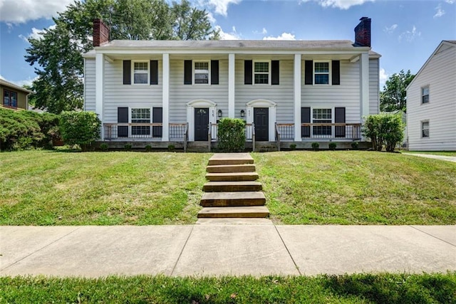 627 E Meyer Blvd, Kansas City, MO 64131 - greek revival house with a chimney, covered porch, and a front lawn