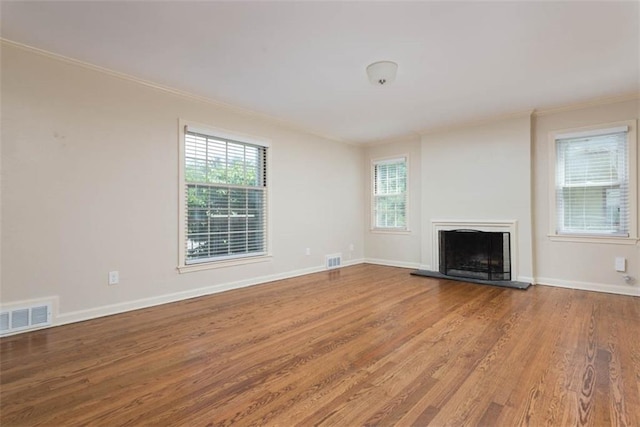 627 E Meyer Blvd, Kansas City, MO 64131 - unfurnished living room featuring crown molding, wood finished floors, and a fireplace with raised hearth