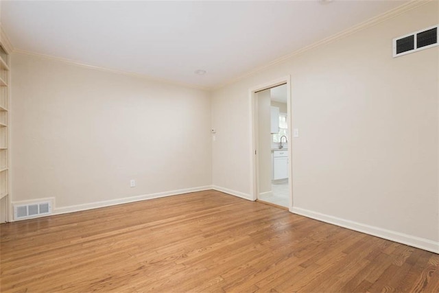 627 E Meyer Blvd, Kansas City, MO 64131 - spare room with ornamental molding and light wood-style floors