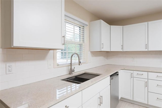 627 E Meyer Blvd, Kansas City, MO 64131 - kitchen with stainless steel dishwasher, white cabinetry, light stone countertops, and tasteful backsplash