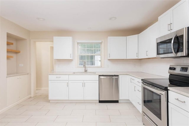 627 E Meyer Blvd, Kansas City, MO 64131 - kitchen featuring appliances with stainless steel finishes, decorative backsplash, light countertops, and white cabinetry