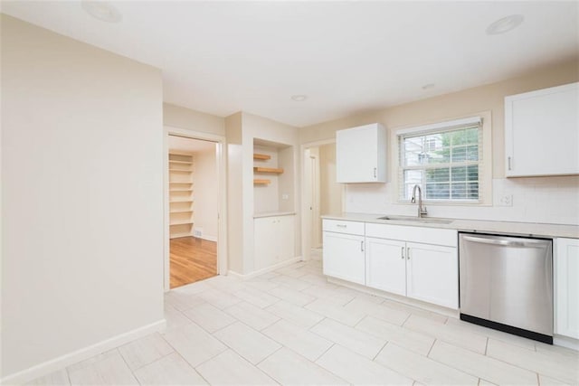 627 E Meyer Blvd, Kansas City, MO 64131 - kitchen with stainless steel dishwasher, light countertops, white cabinetry, tasteful backsplash, and open shelves