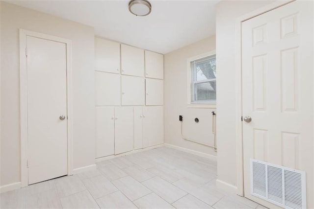 627 E Meyer Blvd, Kansas City, MO 64131 - washroom with cabinet space and baseboards