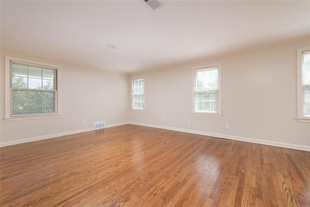 627 E Meyer Blvd, Kansas City, MO 64131 - unfurnished room featuring crown molding, healthy amount of natural light, and wood finished floors