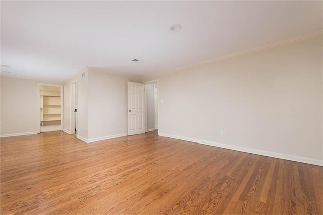 627 E Meyer Blvd, Kansas City, MO 64131 - empty room with light wood finished floors and ornamental molding