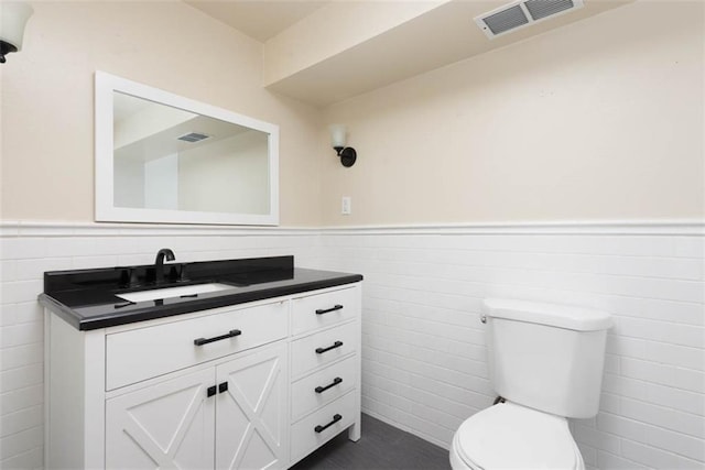 627 E Meyer Blvd, Kansas City, MO 64131 - half bath with tile walls, wainscoting, and vanity
