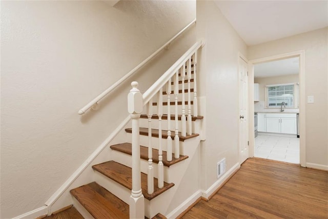 627 E Meyer Blvd, Kansas City, MO 64131 - staircase featuring wood finished floors and baseboards