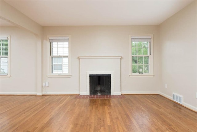 627 E Meyer Blvd, Kansas City, MO 64131 - unfurnished living room with light wood-style flooring and a fireplace