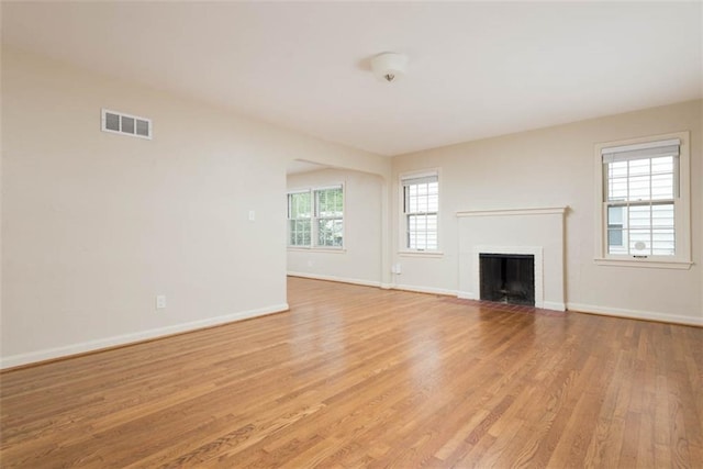 627 E Meyer Blvd, Kansas City, MO 64131 - unfurnished living room with light wood-style floors and a fireplace with flush hearth