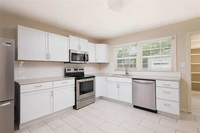 627 E Meyer Blvd, Kansas City, MO 64131 - kitchen with stainless steel appliances, light countertops, white cabinetry, backsplash, and recessed lighting