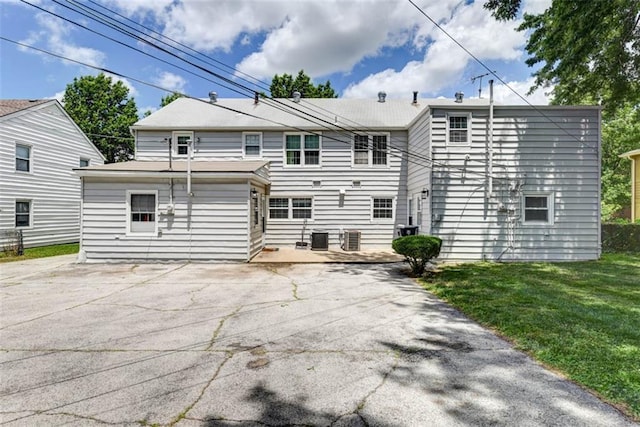 627 E Meyer Blvd, Kansas City, MO 64131 - rear view of house with a patio, a lawn, and driveway