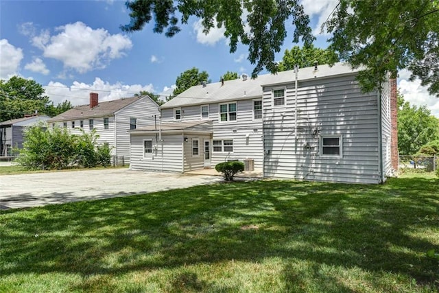 627 E Meyer Blvd, Kansas City, MO 64131 - back of property featuring a patio, a lawn, and a chimney