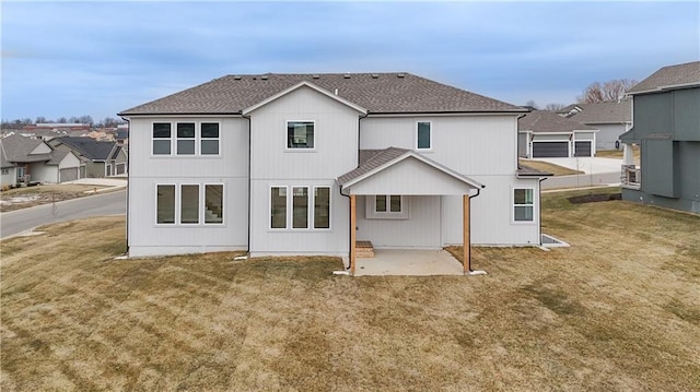 6114 Lewis Dr, Shawnee, KS 66226 - back of house with a patio area, a shingled roof, a lawn, and a residential view