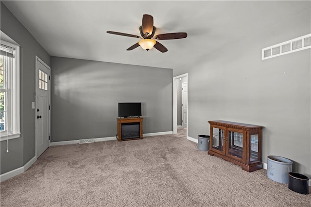 8315 Laurel Ave, Raytown, MO 64138 - unfurnished living room featuring a ceiling fan and carpet