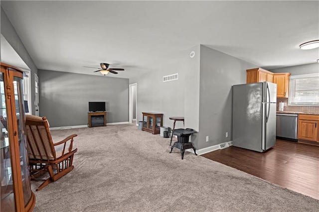 8315 Laurel Ave, Raytown, MO 64138 - living area with a ceiling fan and dark colored carpet
