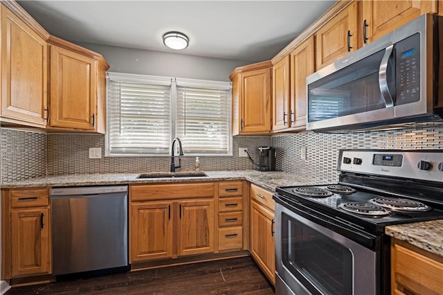 8315 Laurel Ave, Raytown, MO 64138 - kitchen with stainless steel appliances, light stone counters, dark wood-style floors, and decorative backsplash
