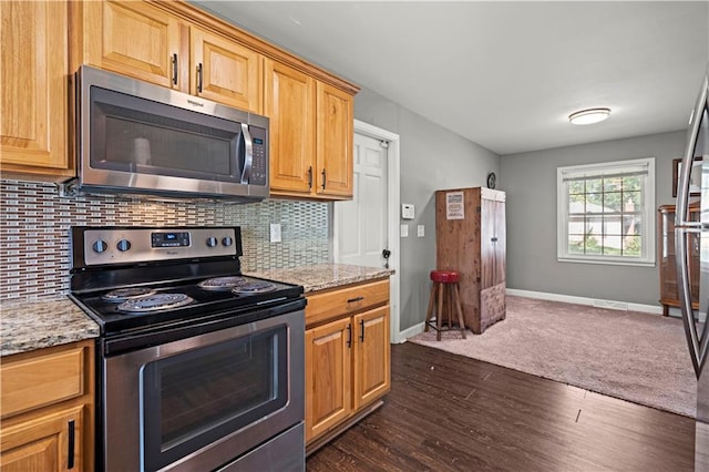 8315 Laurel Ave, Raytown, MO 64138 - kitchen featuring appliances with stainless steel finishes, dark wood finished floors, backsplash, and light stone counters