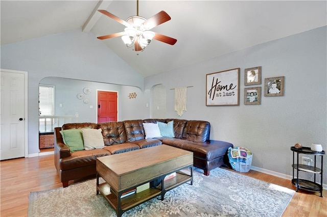 1211 SW Walnut St, Lees Summit, MO 64081 - living room with a ceiling fan, arched walkways, light wood-style floors, beamed ceiling, and high vaulted ceiling